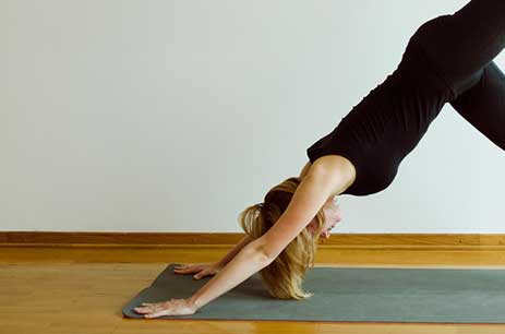 lady doing yoga on mat