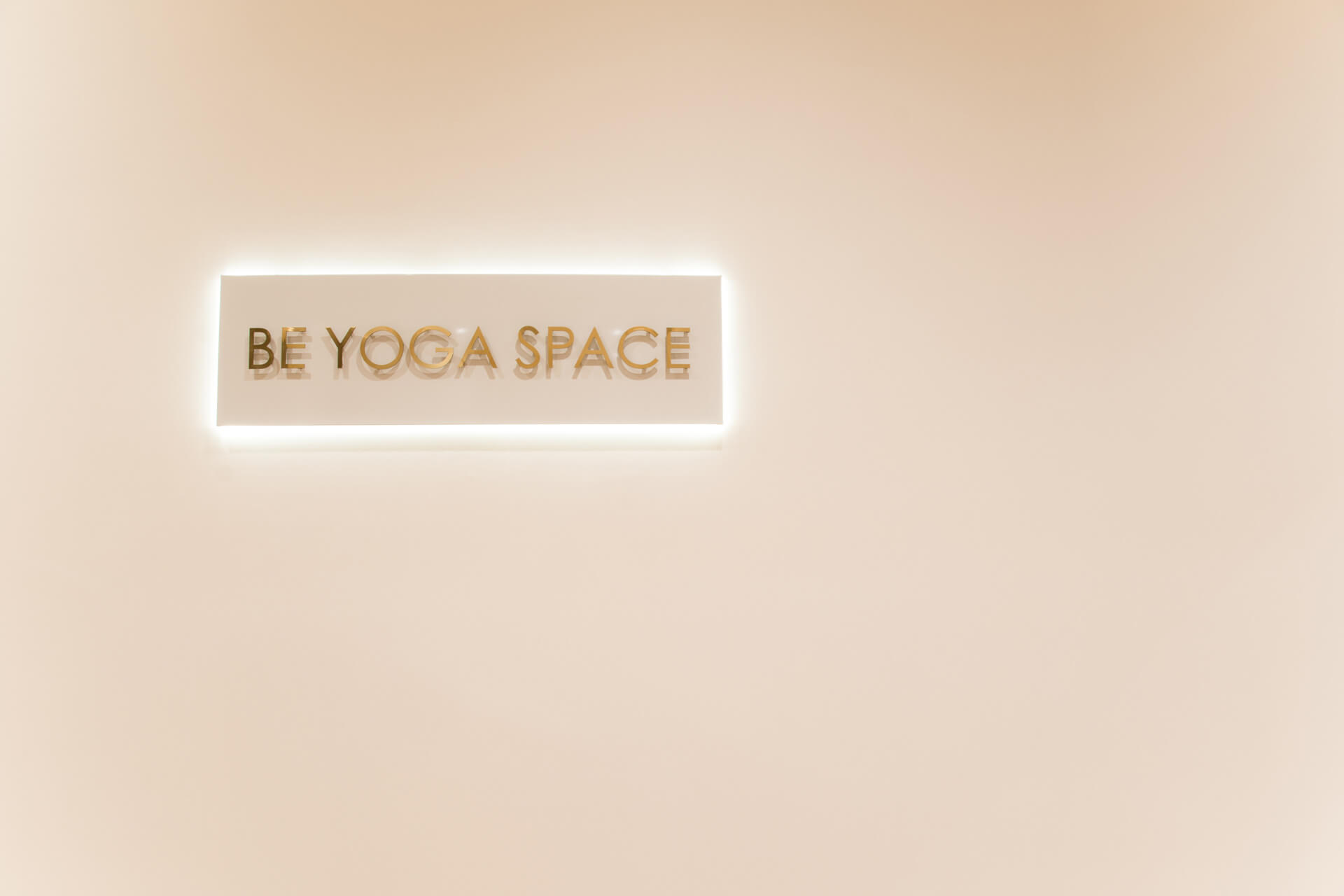 Be Yoga Space sign on white wall